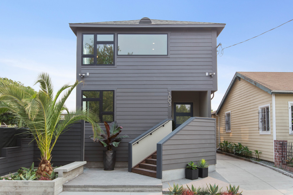 This is an example of a contemporary two-storey grey house exterior in San Francisco with a hip roof, a shingle roof, a grey roof and clapboard siding.