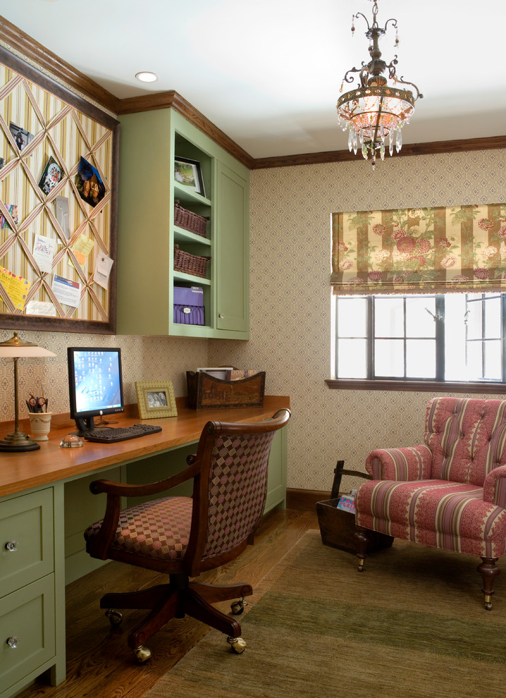 This is an example of a mid-sized traditional home office in Boston with beige walls, dark hardwood floors and a built-in desk.