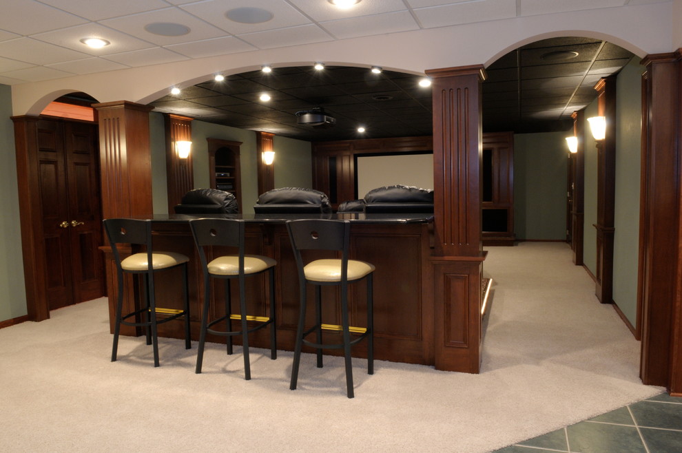 Basement - large transitional underground carpeted and beige floor basement idea with green walls and no fireplace