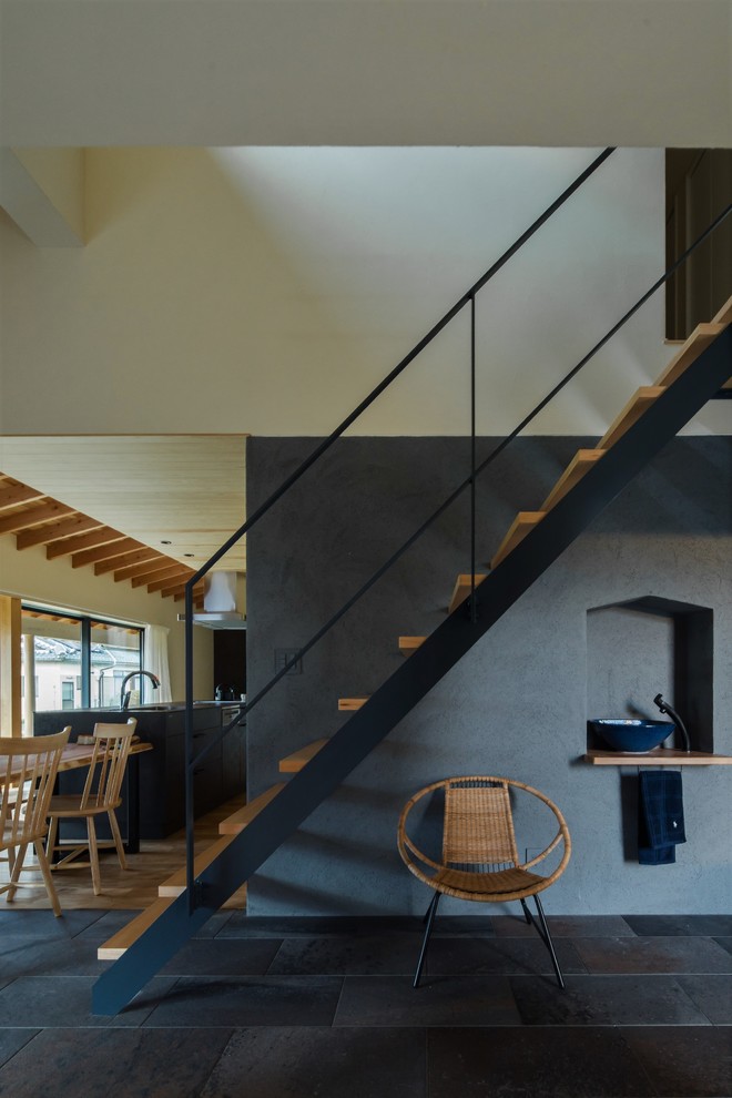 Inspiration for a mid-sized asian wood straight staircase in Other with open risers and metal railing.