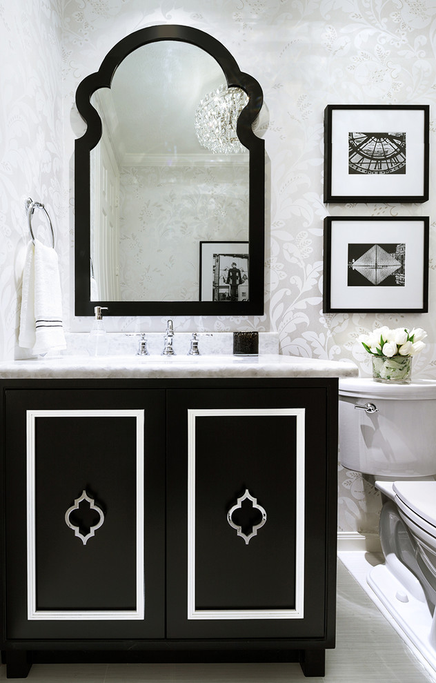 Inspiration for a small transitional porcelain tile and white floor powder room remodel in Houston with furniture-like cabinets, black cabinets, a one-piece toilet, a drop-in sink, quartzite countertops and white walls