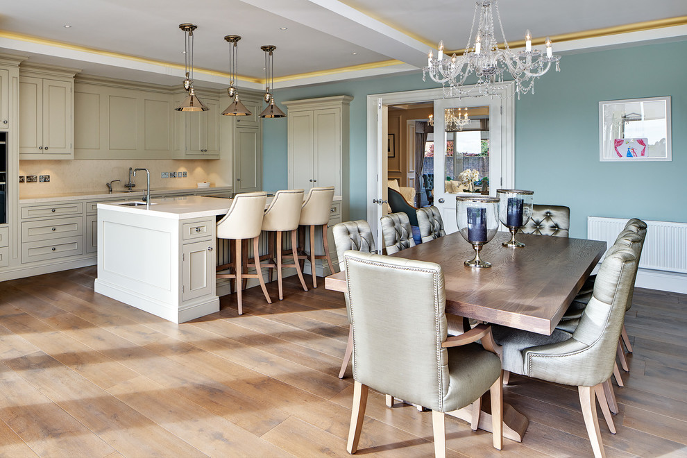 This is an example of a large traditional open plan kitchen in Other with with island, recessed-panel cabinets, white cabinets, white splashback and panelled appliances.