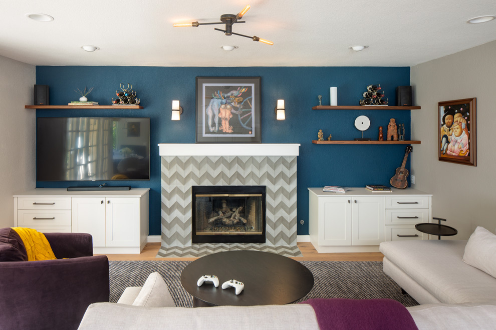 Mid-sized transitional open concept living room in San Diego with blue walls, a standard fireplace, a tile fireplace surround and a wall-mounted tv.