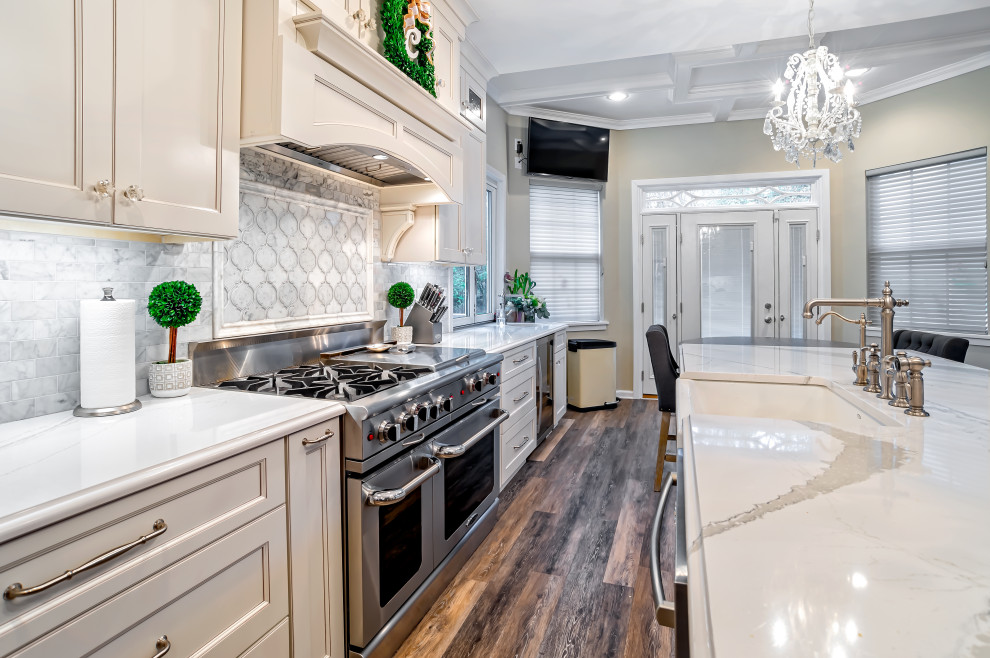 Example of a large transitional single-wall medium tone wood floor and brown floor eat-in kitchen design in Philadelphia with a farmhouse sink, shaker cabinets, white cabinets, quartz countertops, gray backsplash, porcelain backsplash, stainless steel appliances, an island and white countertops