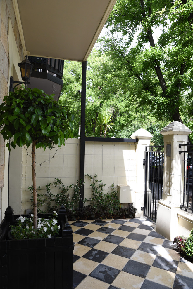 Small traditional courtyard partial sun formal garden in Adelaide with a vertical garden and concrete pavers.