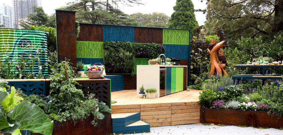 Photo of an eclectic courtyard patio in Melbourne with an outdoor kitchen, decking and no cover.