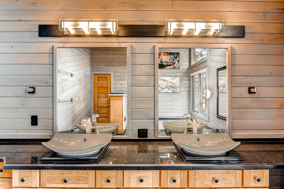 Mid-sized country master bathroom in Denver with flat-panel cabinets, light wood cabinets, a corner shower, a one-piece toilet, black tile, cement tile, brown walls, concrete floors, a vessel sink and quartzite benchtops.