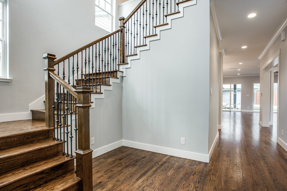 Design ideas for a large arts and crafts wood u-shaped staircase in Dallas with wood risers.