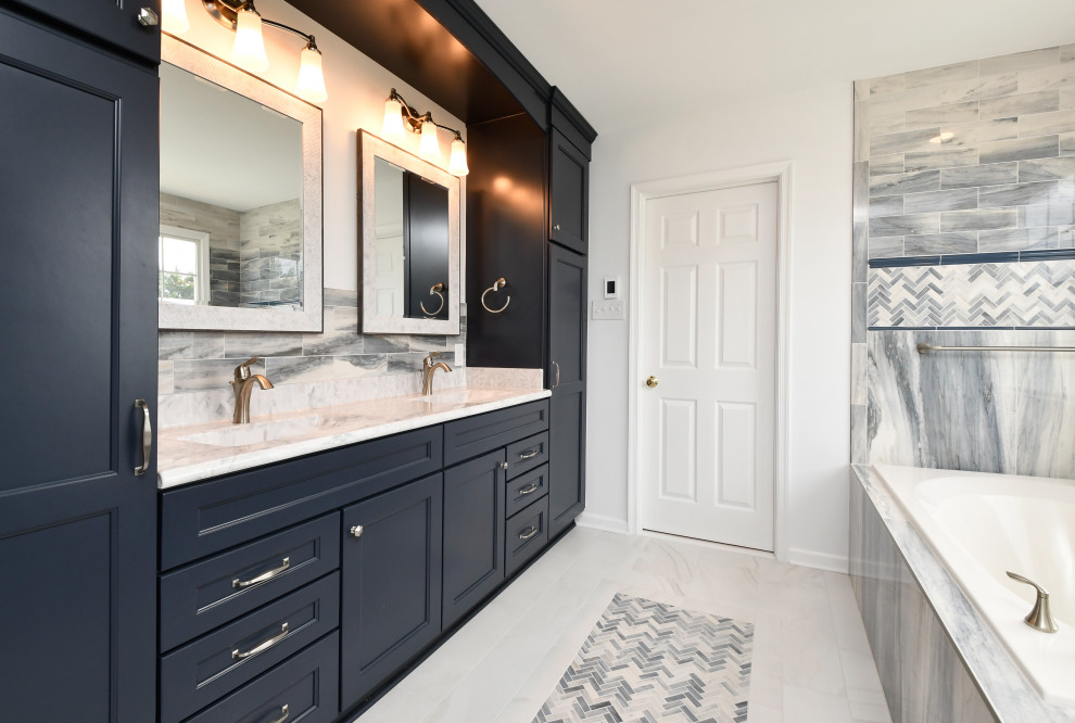 Inspiration for a mid-sized bathroom in DC Metro with blue cabinets, a shower/bathtub combo, with a sauna, an integrated sink, marble benchtops, a shower seat, a double vanity and a built-in vanity.