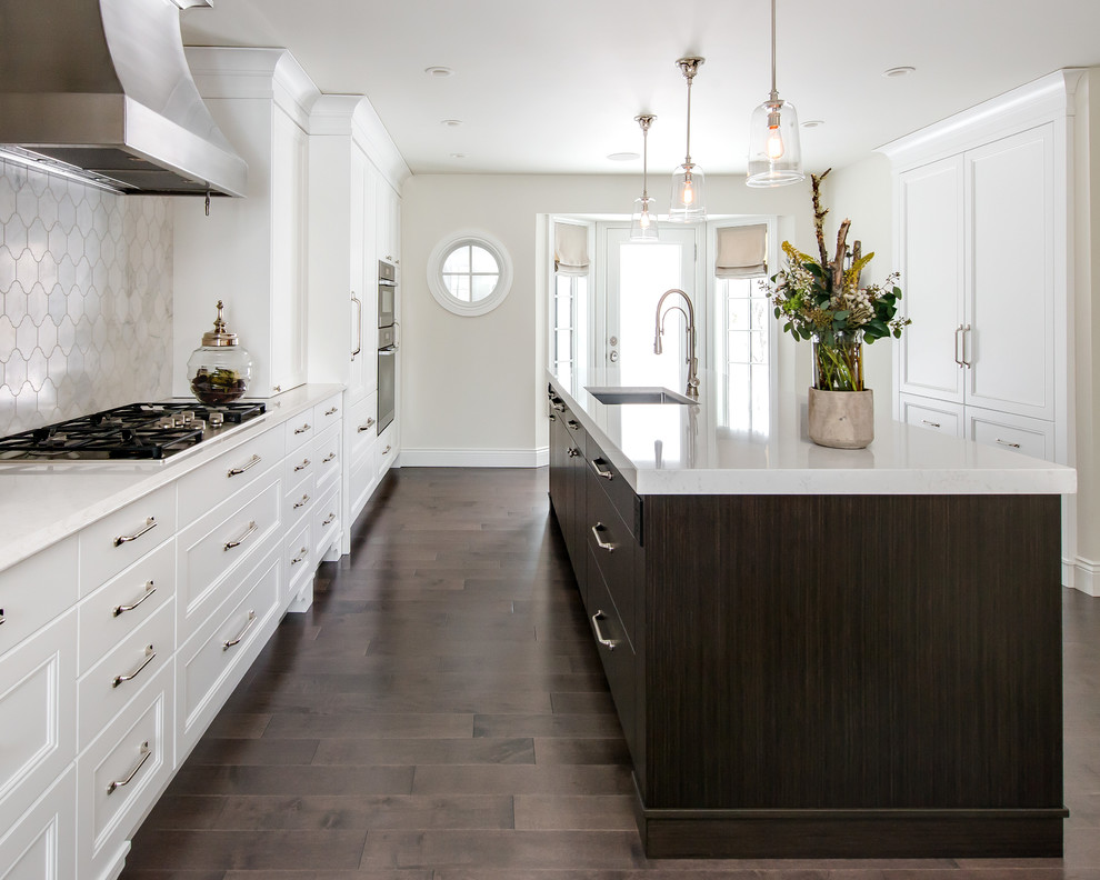 Example of a large transitional single-wall dark wood floor eat-in kitchen design in Calgary with an undermount sink, white cabinets, quartz countertops, multicolored backsplash, stone tile backsplash, paneled appliances and an island