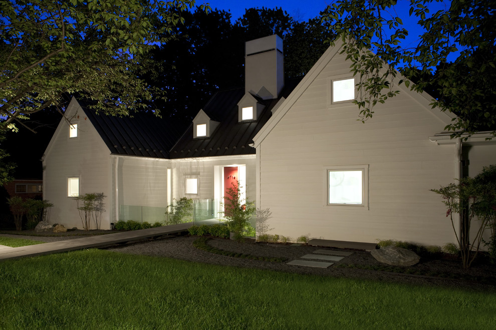 Photo of a large transitional one-storey white house exterior in DC Metro with wood siding and a metal roof.