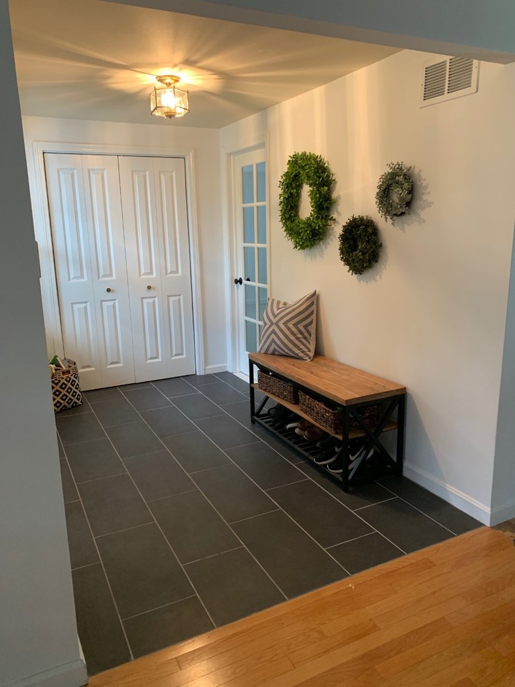 Design ideas for a mid-sized contemporary mudroom in Bridgeport with porcelain floors and grey floor.