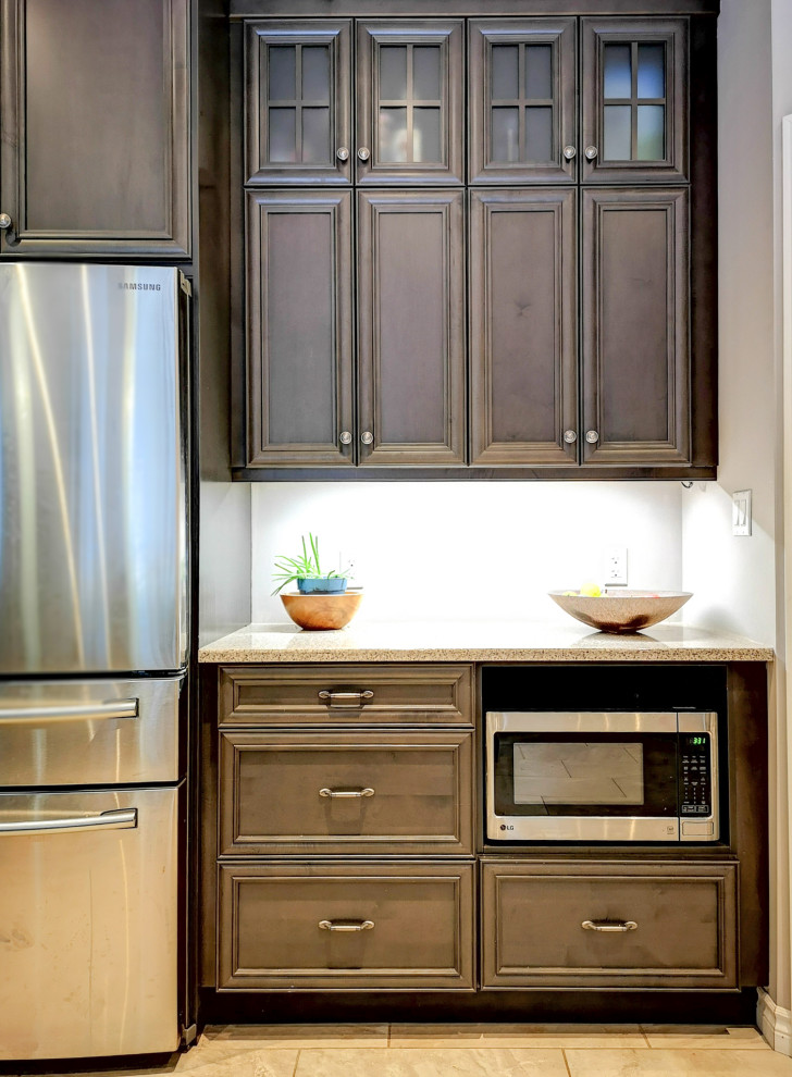 Inspiration for a mid-sized rustic l-shaped medium tone wood floor and brown floor eat-in kitchen remodel with a double-bowl sink, recessed-panel cabinets, dark wood cabinets, granite countertops, stainless steel appliances, an island and gray countertops