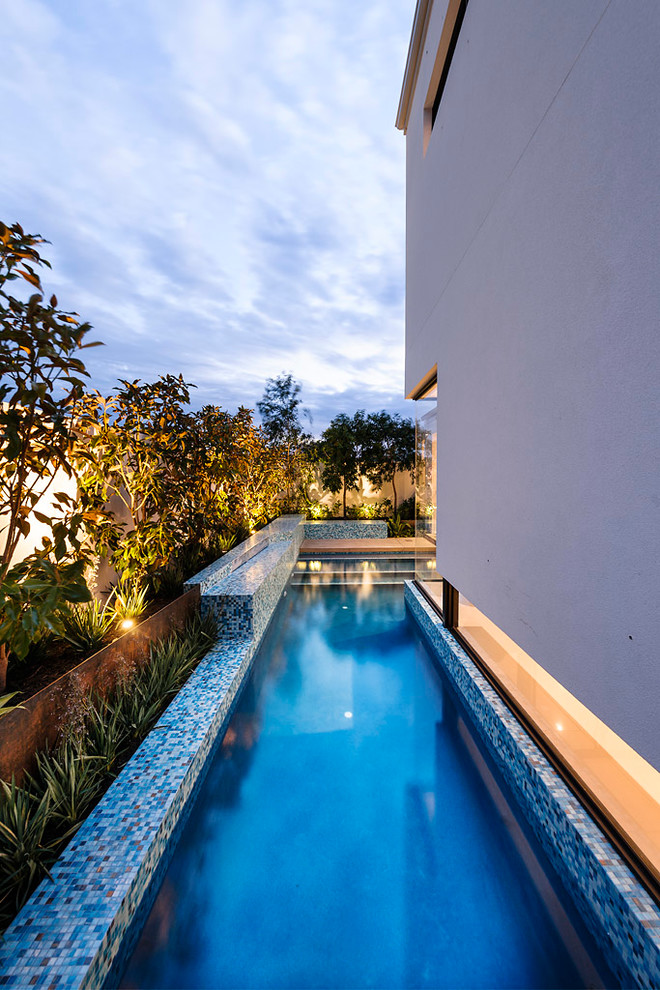 Inspiration for a contemporary side yard custom-shaped lap pool in Perth.