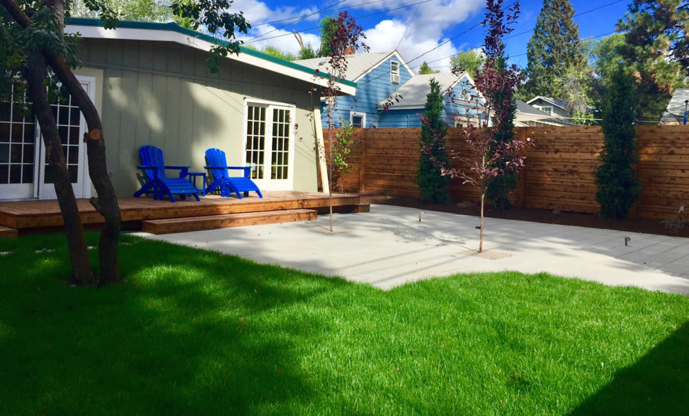 Mid-sized midcentury backyard partial sun garden in Other with decking.