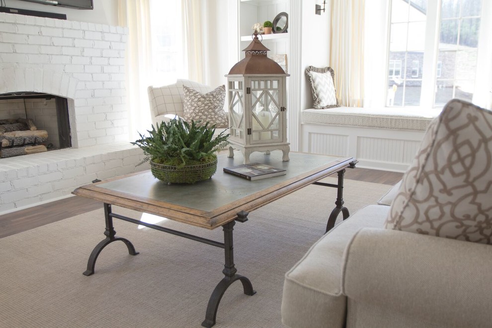 Mid-sized country enclosed living room in Birmingham with white walls, dark hardwood floors, a standard fireplace, a brick fireplace surround, a wall-mounted tv and brown floor.