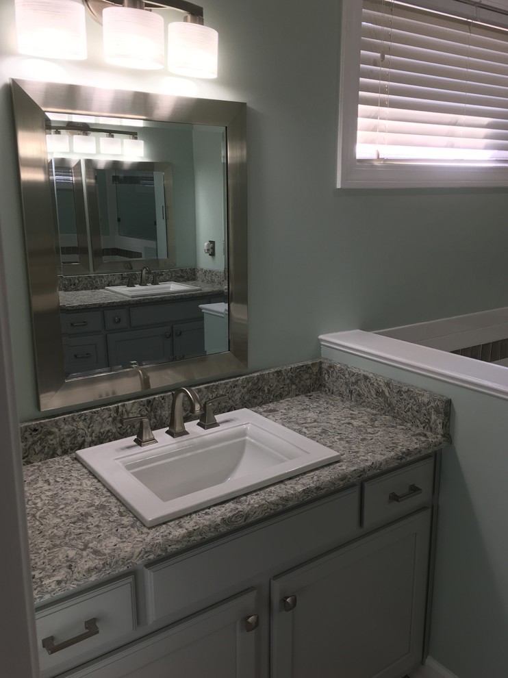 Bathroom - mid-sized transitional master porcelain tile and multicolored floor bathroom idea with raised-panel cabinets, gray cabinets, green walls, a drop-in sink and quartzite countertops