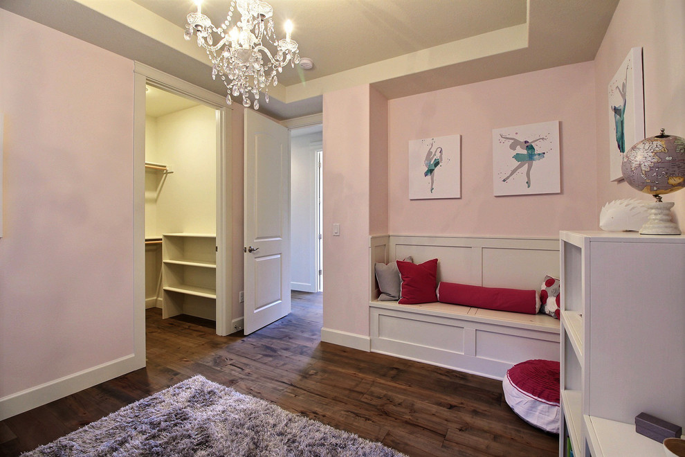 Inspiration for an expansive arts and crafts kids' bedroom for kids 4-10 years old and girls in Portland with pink walls, medium hardwood floors and brown floor.