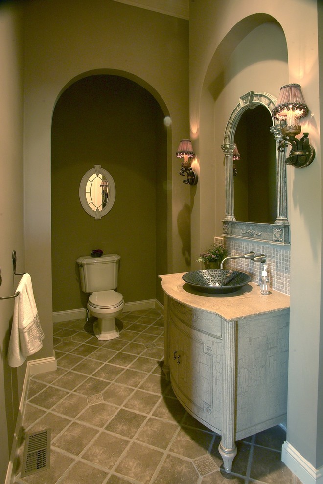 This is an example of a mid-sized traditional powder room in Boston with a vessel sink, furniture-like cabinets, granite benchtops, beige tile, grey walls, marble floors, beige cabinets, a two-piece toilet and mosaic tile.