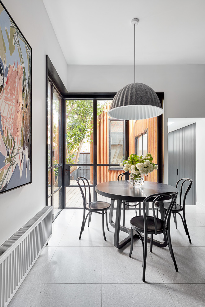Mid-sized contemporary kitchen/dining combo in Melbourne with white walls and grey floor.