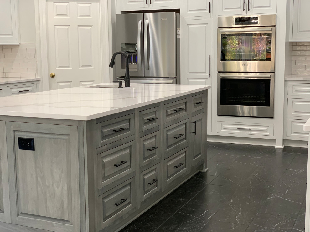 Transitional marble floor and black floor eat-in kitchen photo with an undermount sink, quartz countertops, ceramic backsplash, stainless steel appliances, an island and white countertops