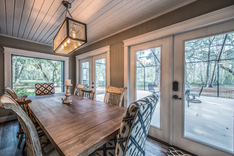 Mid-sized country separate dining room in Tampa with grey walls, vinyl floors and grey floor.