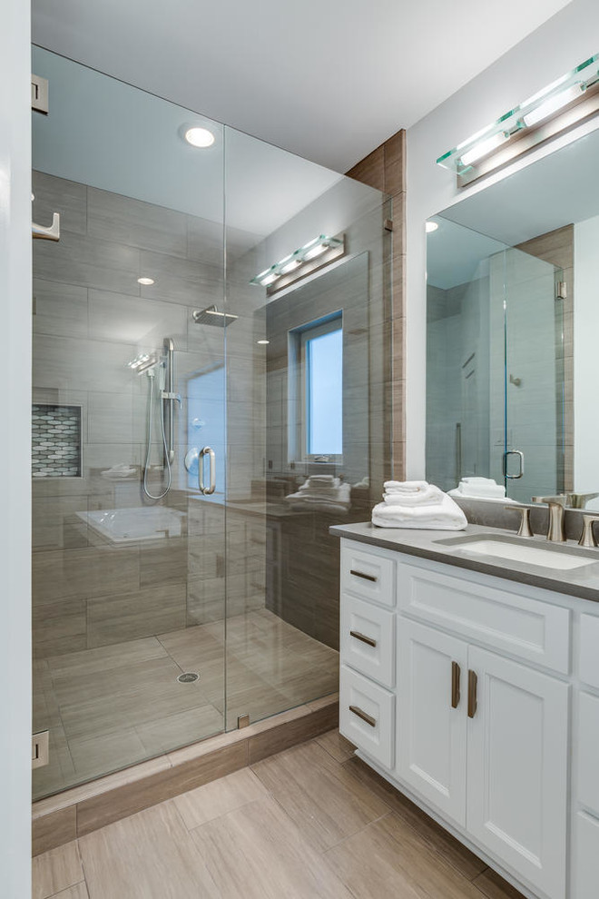 Inspiration for a mid-sized contemporary master bathroom in Austin with shaker cabinets, white cabinets, a drop-in tub, an alcove shower, beige tile, porcelain tile, grey walls, porcelain floors, an undermount sink, beige floor and a hinged shower door.