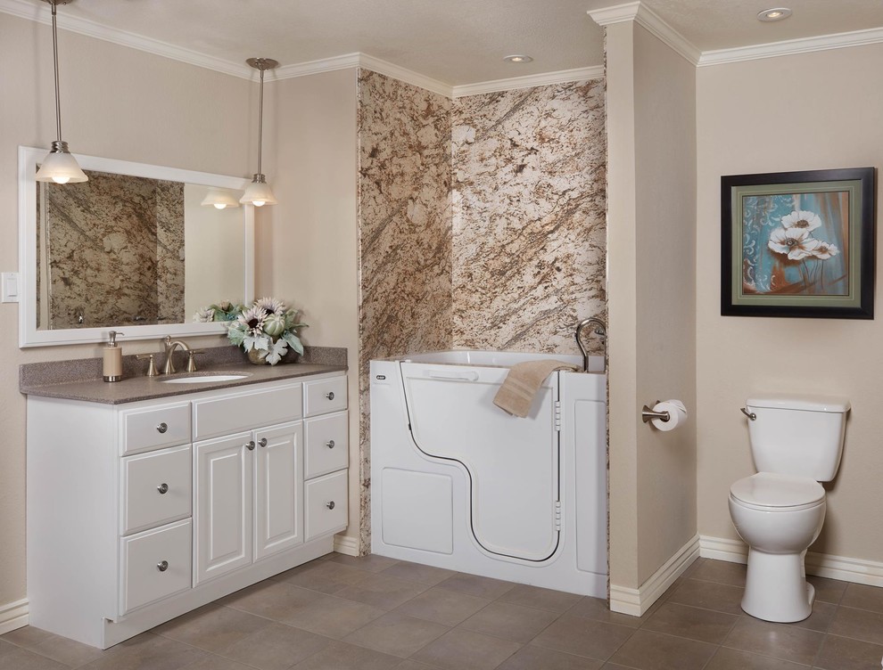 This is an example of a mid-sized transitional master bathroom in Miami with raised-panel cabinets, white cabinets, a shower/bathtub combo, a two-piece toilet, brown tile, stone slab, brown walls, ceramic floors, an undermount sink, granite benchtops, brown floor and a hinged shower door.