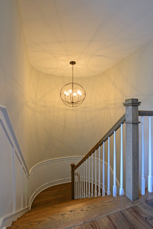 This is an example of a mid-sized beach style wood l-shaped staircase in Other with painted wood risers.