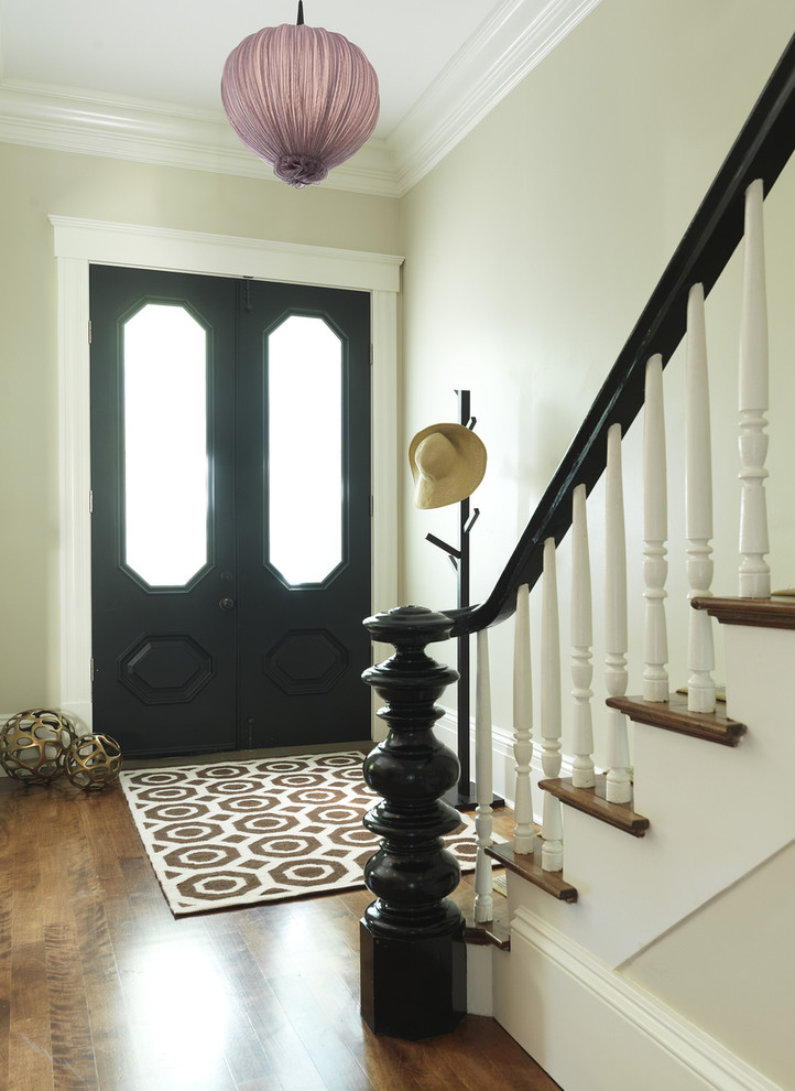 Traditional entryway in Boston with beige walls, a double front door, a black front door and medium hardwood floors.