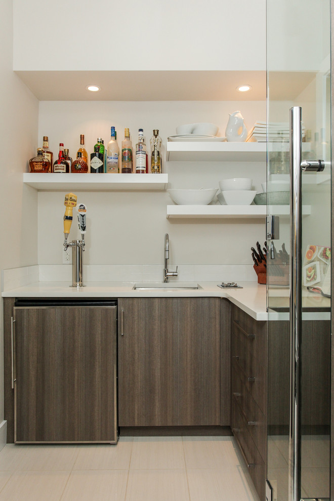 Photo of a small contemporary l-shaped home bar in Edmonton with an undermount sink, flat-panel cabinets, dark wood cabinets and white benchtop.