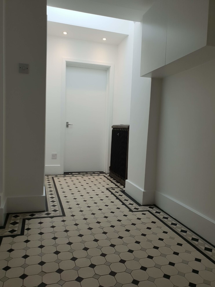 Design ideas for an expansive traditional hallway in London with white walls, dark hardwood floors, black floor and recessed.