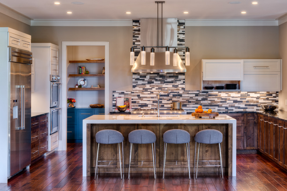 This is an example of a large contemporary u-shaped kitchen in Other with granite benchtops, glass tile splashback, stainless steel appliances, with island, shaker cabinets, dark wood cabinets and dark hardwood floors.