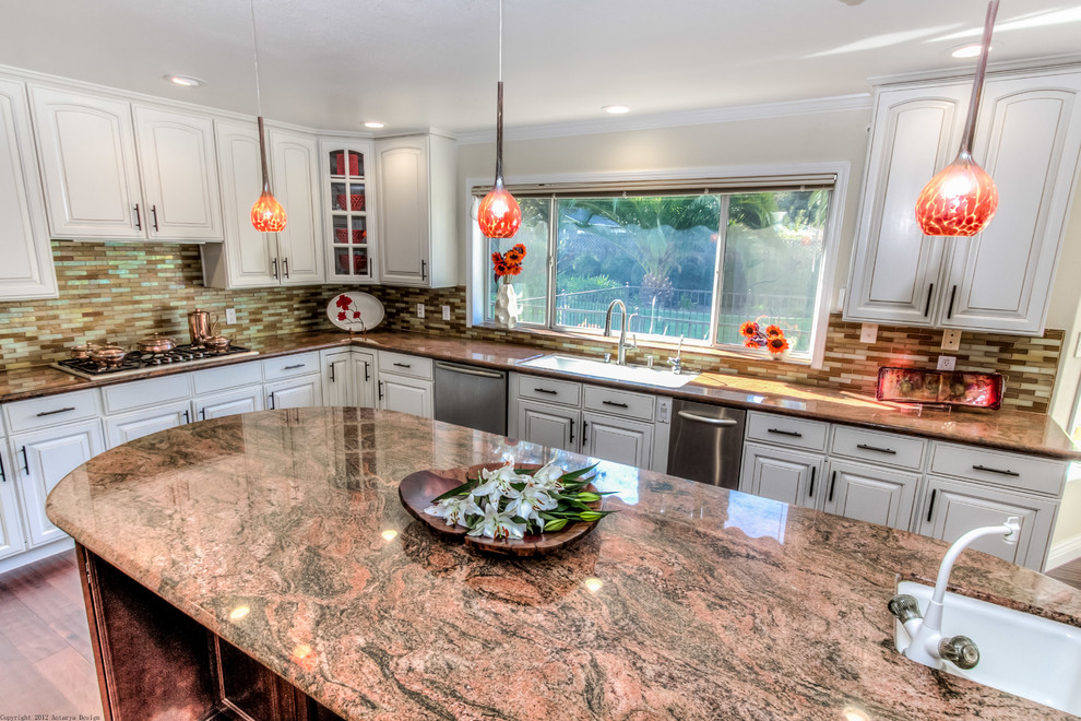 Large transitional l-shaped eat-in kitchen in San Francisco with an undermount sink, raised-panel cabinets, white cabinets, granite benchtops, multi-coloured splashback, mosaic tile splashback, stainless steel appliances, medium hardwood floors, with island, brown floor and red benchtop.