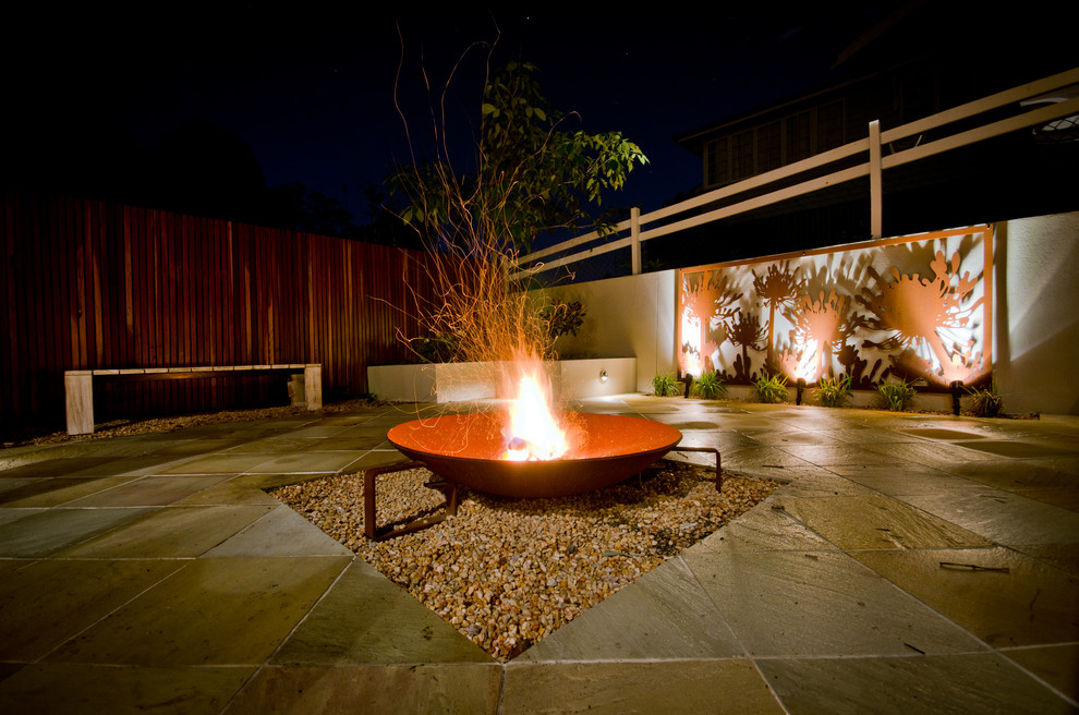 Inspiration for a mid-sized modern backyard full sun garden for summer in Other with a fire feature and brick pavers.