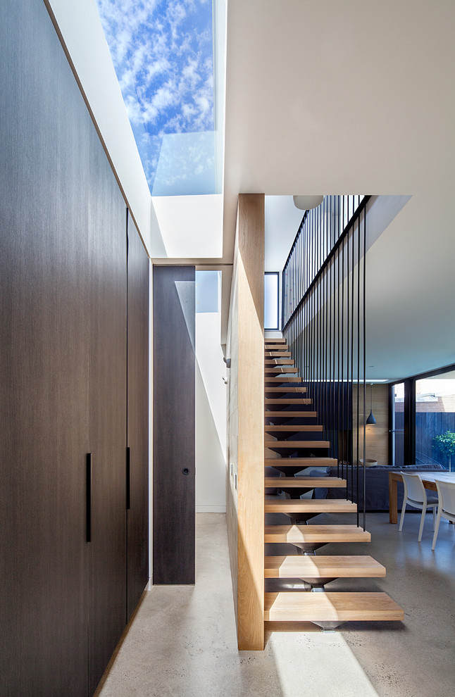 Inspiration for a contemporary wood straight staircase in Melbourne with open risers.
