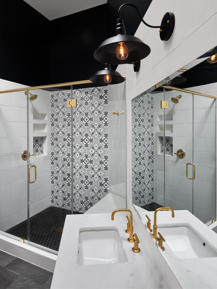 This is an example of a large transitional 3/4 bathroom in DC Metro with shaker cabinets, white cabinets, white tile, black and white tile, an undermount sink, a hinged shower door, cement tile, a corner shower, a two-piece toilet, black walls, slate floors, marble benchtops and black floor.