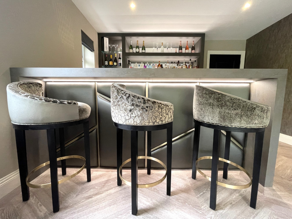 Example of a mid-sized trendy u-shaped vinyl floor home bar design in Other with flat-panel cabinets