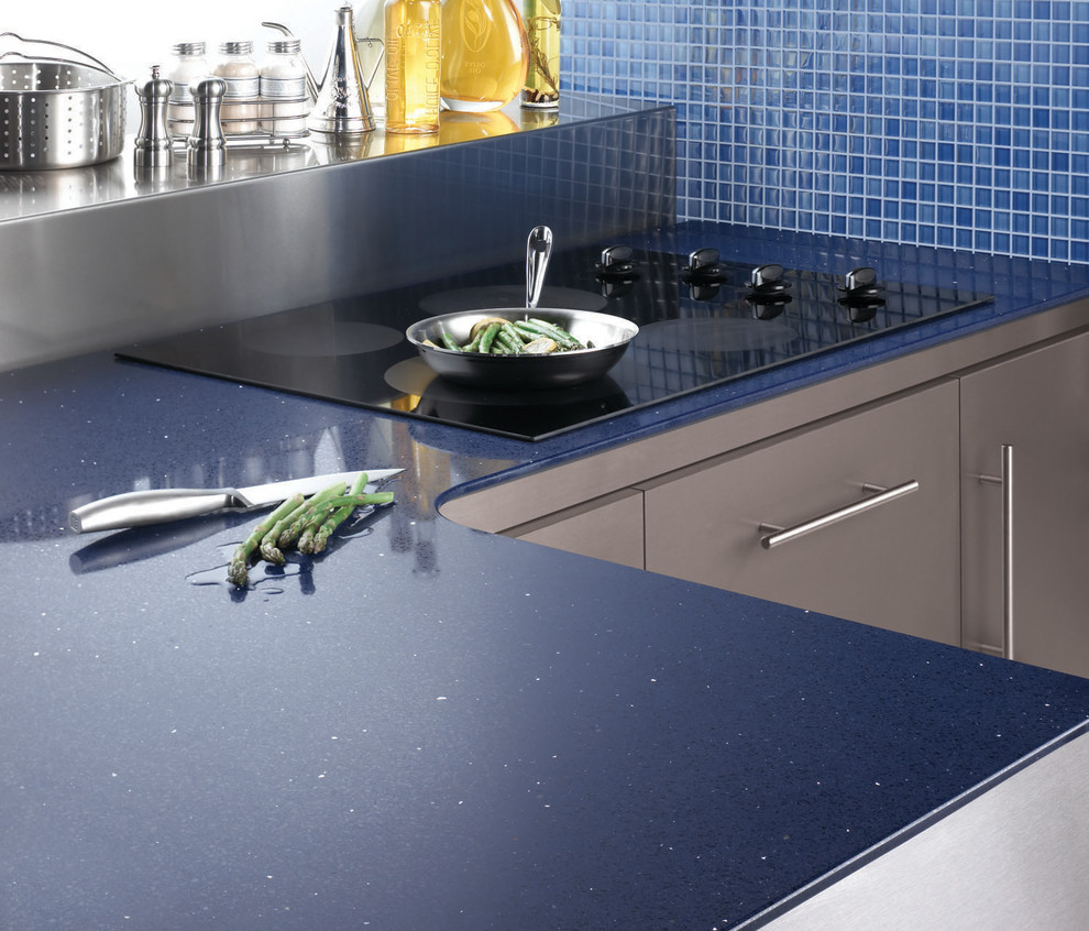 Mid-sized trendy u-shaped ceramic tile eat-in kitchen photo with a drop-in sink, raised-panel cabinets, white cabinets, soapstone countertops, beige backsplash, stone slab backsplash, stainless steel appliances and no island