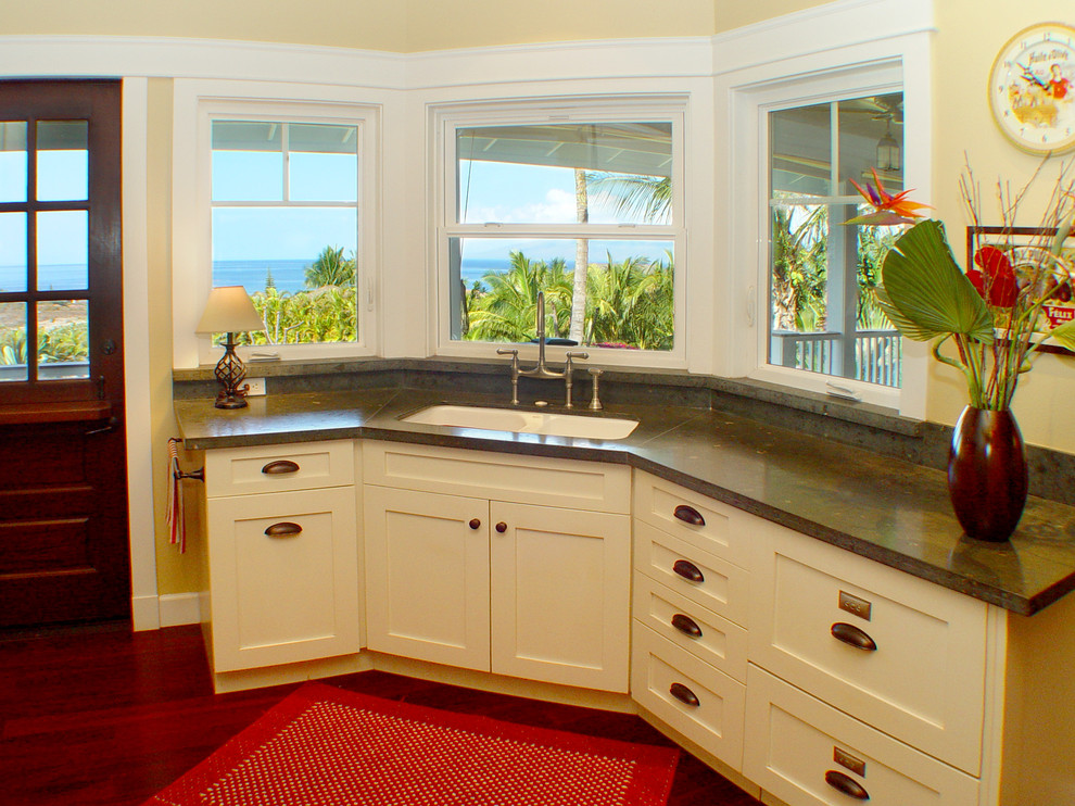 Photo of a beach style kitchen in Hawaii with limestone benchtops.