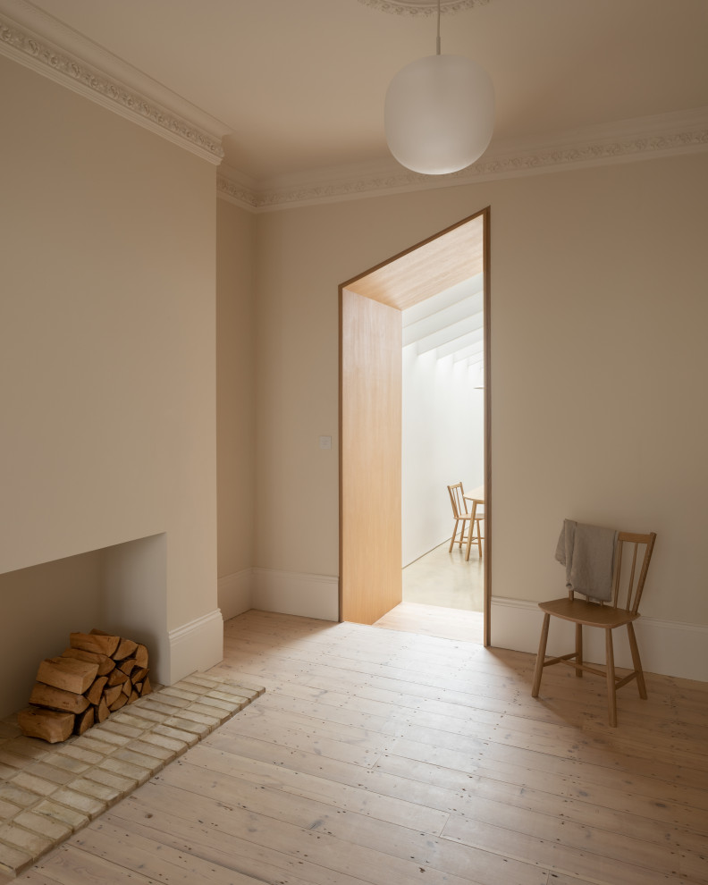 Design ideas for a scandinavian living room in London with no fireplace, a brick fireplace surround, a concealed tv and a chimney breast.
