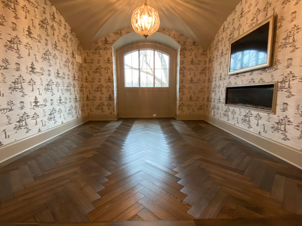 This is an example of a mid-sized traditional home studio in Atlanta with multi-coloured walls, dark hardwood floors, a standard fireplace, a freestanding desk, black floor, vaulted and wallpaper.