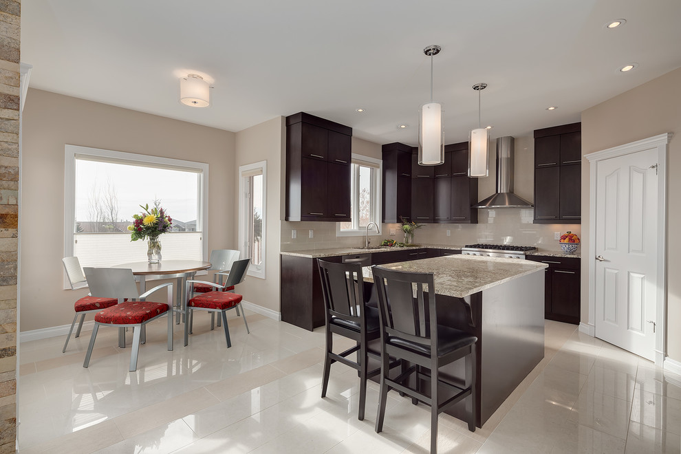 Design ideas for a transitional u-shaped separate kitchen in Calgary with with island, flat-panel cabinets, dark wood cabinets, granite benchtops, beige splashback, stainless steel appliances and an undermount sink.