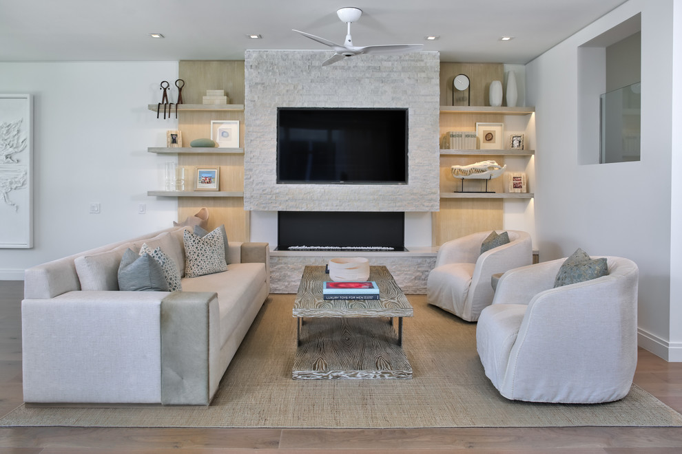 Design ideas for a mid-sized contemporary formal open concept living room in Miami with white walls, light hardwood floors, a ribbon fireplace, a stone fireplace surround and a built-in media wall.