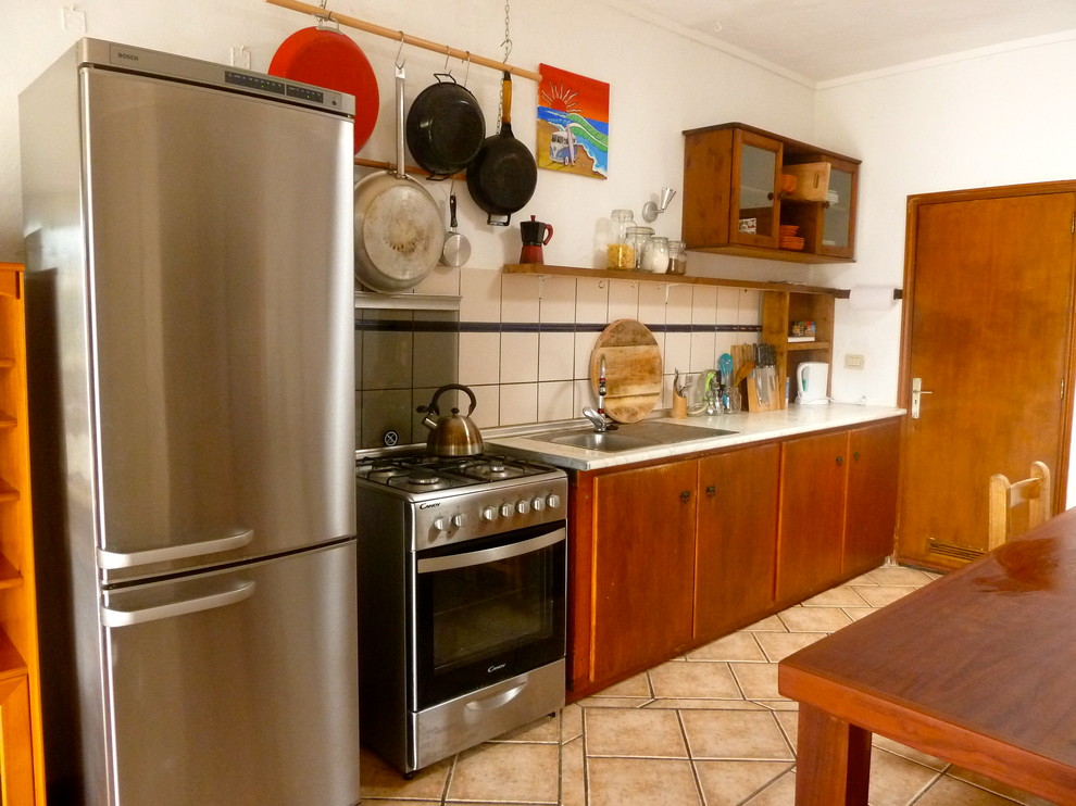 Small mountain style single-wall ceramic tile eat-in kitchen photo with an undermount sink, flat-panel cabinets, medium tone wood cabinets, stainless steel appliances and no island