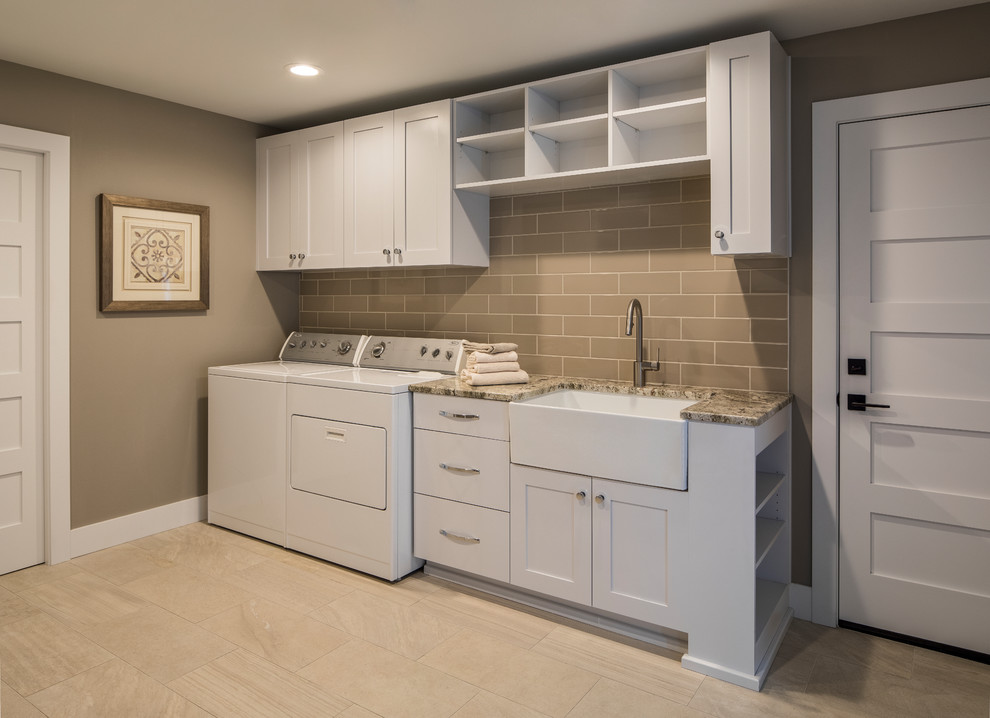 Design ideas for a mid-sized transitional galley utility room in Portland with a farmhouse sink, shaker cabinets, white cabinets, granite benchtops, brown walls, porcelain floors, a side-by-side washer and dryer, brown floor and brown benchtop.