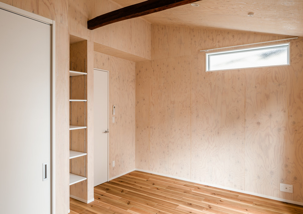 Mid-sized scandinavian formal open concept living room in Other with brown walls, medium hardwood floors, no fireplace, no tv, beige floor, exposed beam and wood walls.