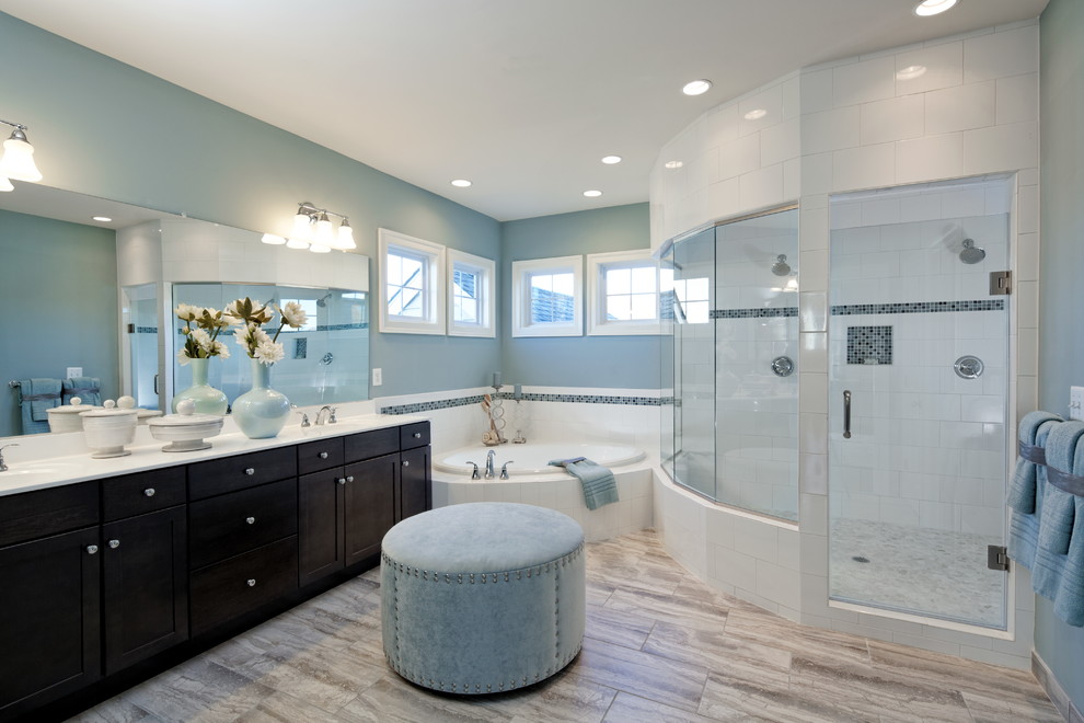 This is an example of a large transitional master wet room bathroom in DC Metro with shaker cabinets, black cabinets, a drop-in tub, blue tile, white tile, porcelain tile, blue walls, porcelain floors, an integrated sink and engineered quartz benchtops.