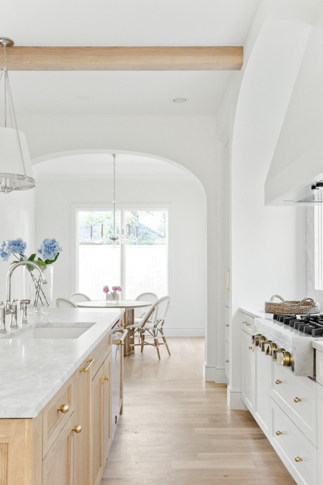 Inspiration for a beach style single-wall eat-in kitchen in Dallas with an undermount sink, shaker cabinets, blue cabinets, marble benchtops, grey splashback, marble splashback, stainless steel appliances, marble floors, with island, white floor, grey benchtop and exposed beam.