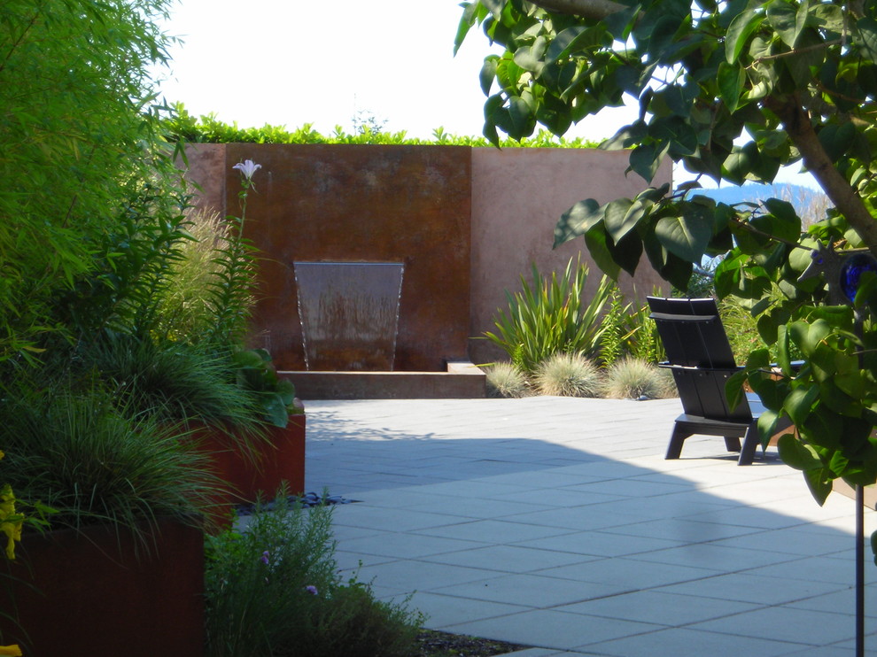 Inspiration for a contemporary patio in Seattle with a water feature.